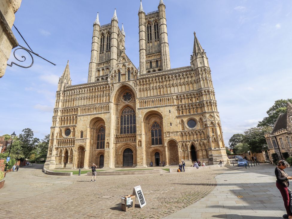 A cathedral with towers and an entrance in Lincoln