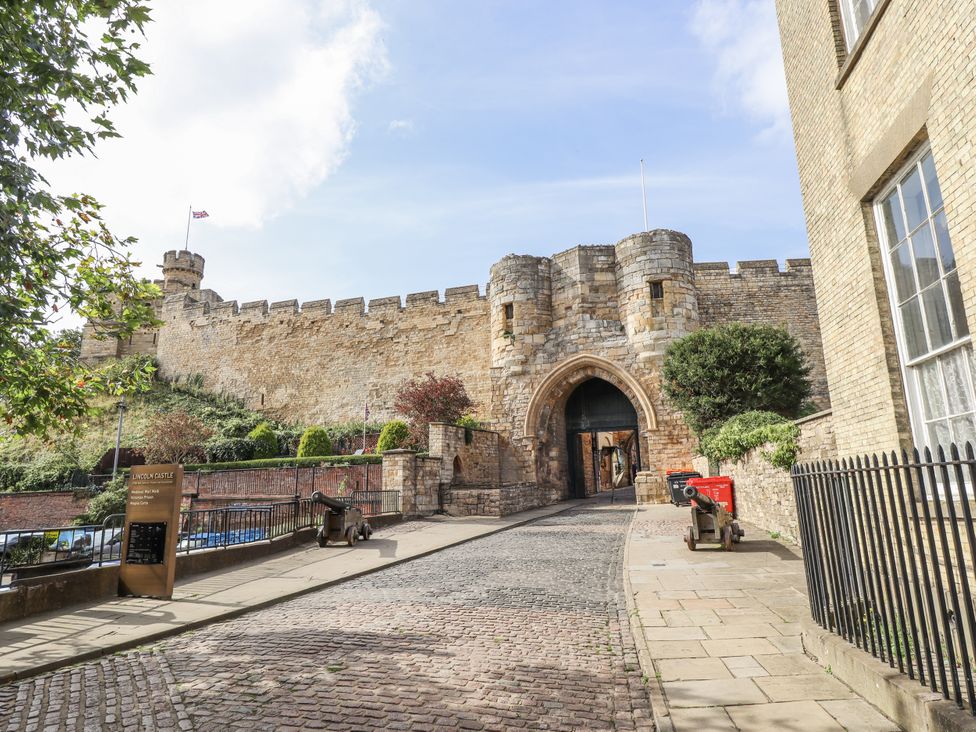 A castle entrance with stone wall and pathway at Lincoln Castle in Lincoln