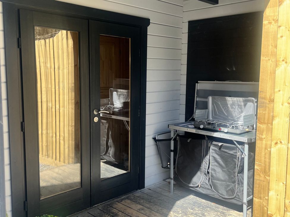 An outdoor kitchen area with a cooking stove and storage bags at Sea La Vie in Perranporth