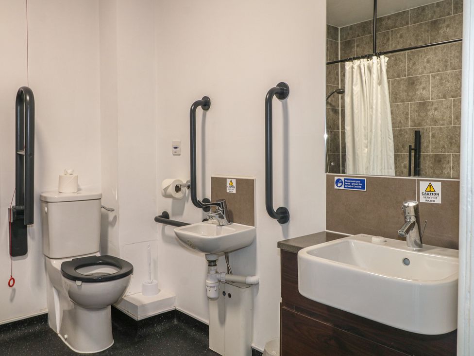 A bathroom with a toilet and sink at Bedroom 4 in Littlehampton
