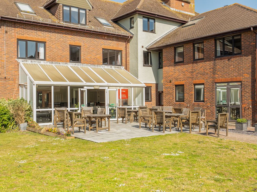 An outdoor seating area with tables and chairs at Marine Court Ground-floor Accessible Double in Littlehampton