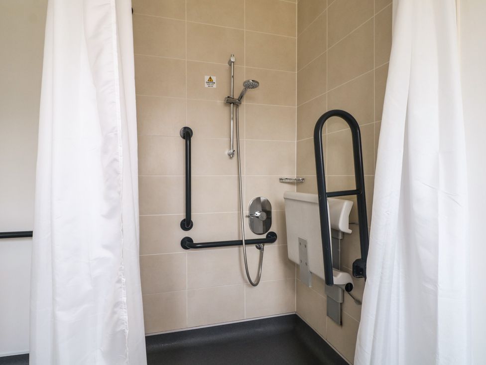 A bathroom with a shower and toilet at Bedroom 6 Littlehampton