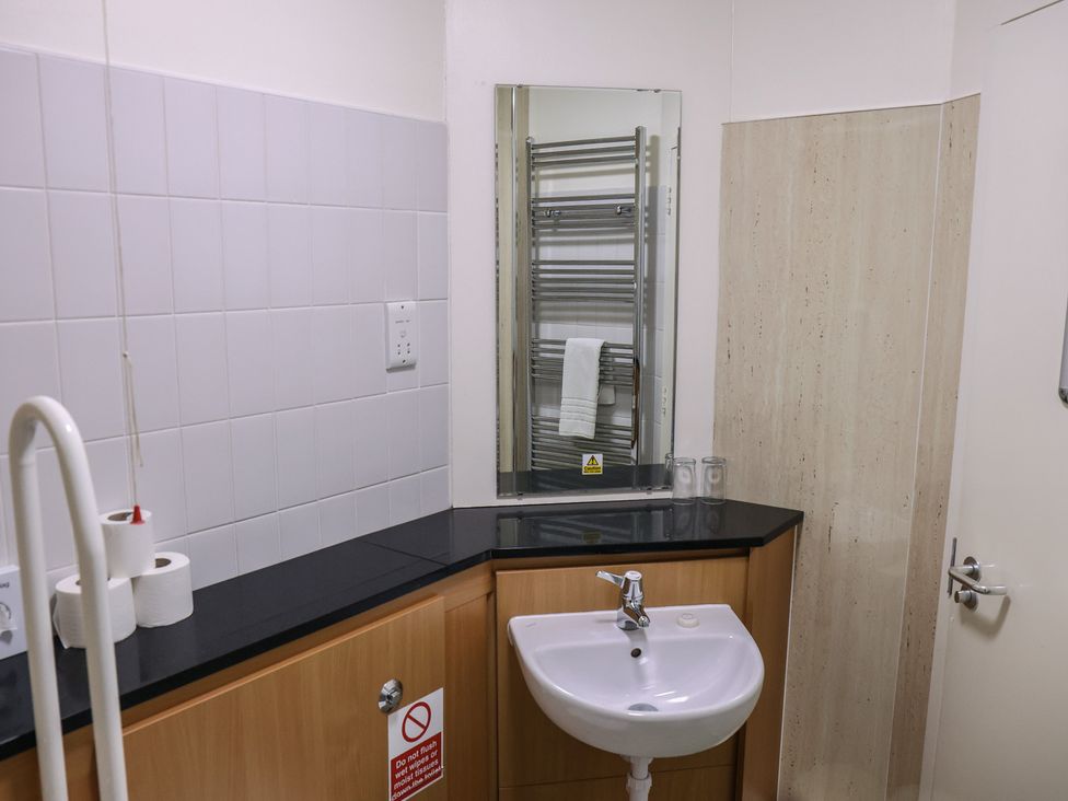 A bathroom with sink and mirror at Bedroom 33