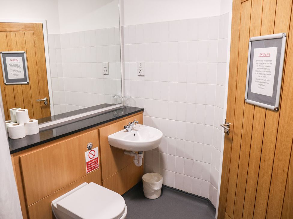 A bathroom with a sink and toilet at Bedroom 36 in Penrith