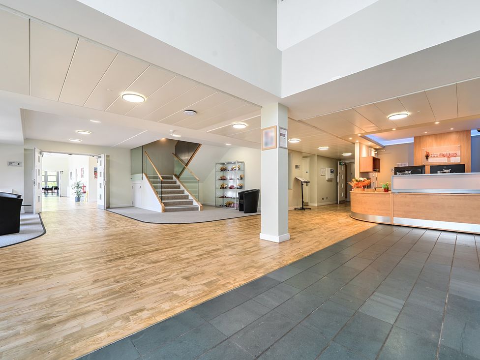A lobby with a reception desk and staircase at Jubilee First-floor King-size Bedroom in Penrith