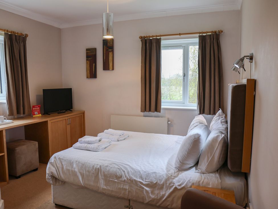 A bedroom with a bed and television at Bedroom 21 in Penrith