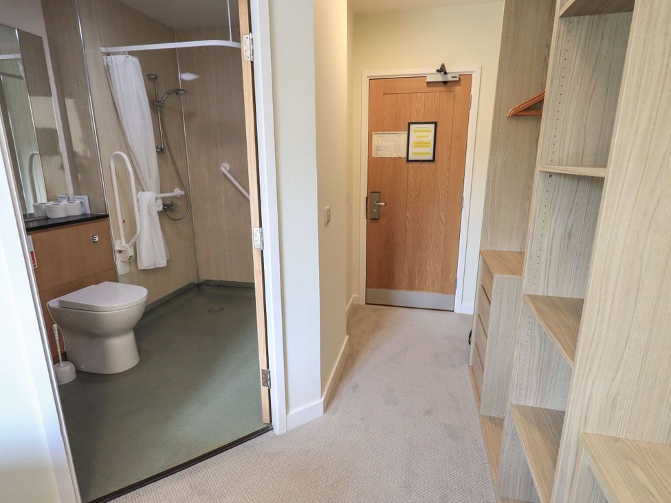 A bathroom with a toilet and shower at Eamont Park First-floor Double Bedroom in Penrith