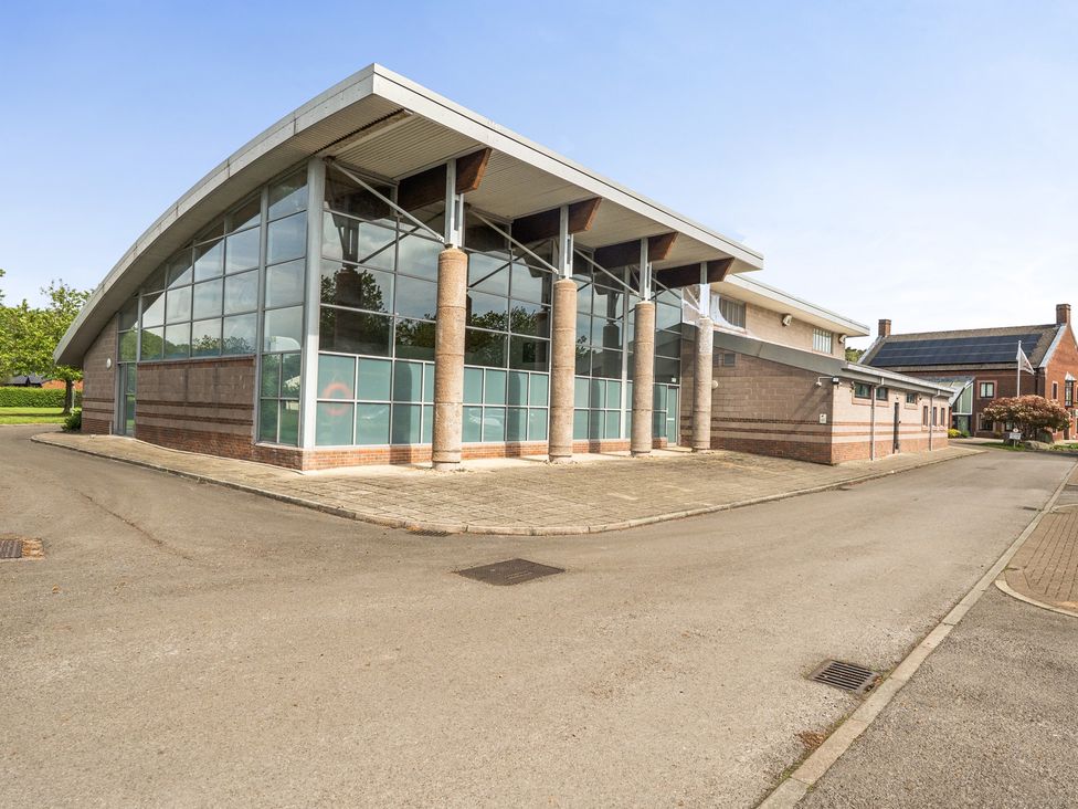 A building with a glass facade and columns at Jubilee First-floor Double Bedroom Penrith