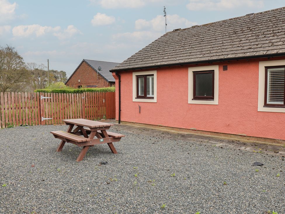 An outdoor area with a picnic table and gravel at Bungalow 19 Eamont Park Penrith