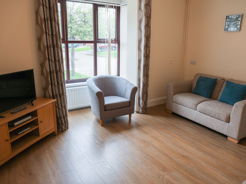 A living room with a sofa and armchair at Bungalow 15 Eamont Park in Penrith