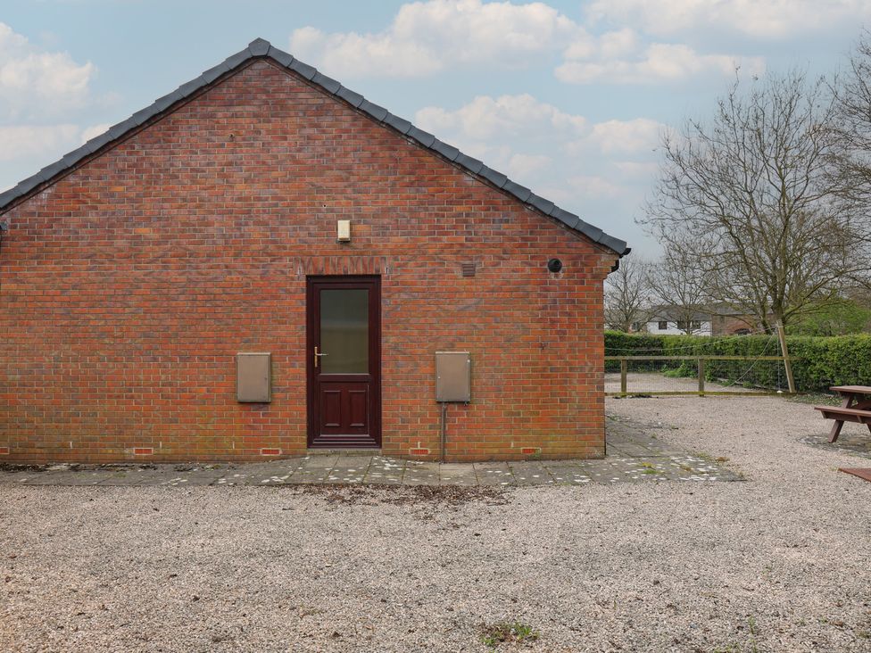 A brick wall with a door at Bungalow 15 Eamont Park Penrith