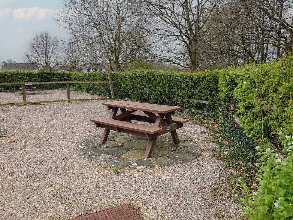 A picnic table in an outdoor setting at Bungalow 15 Eamont Park