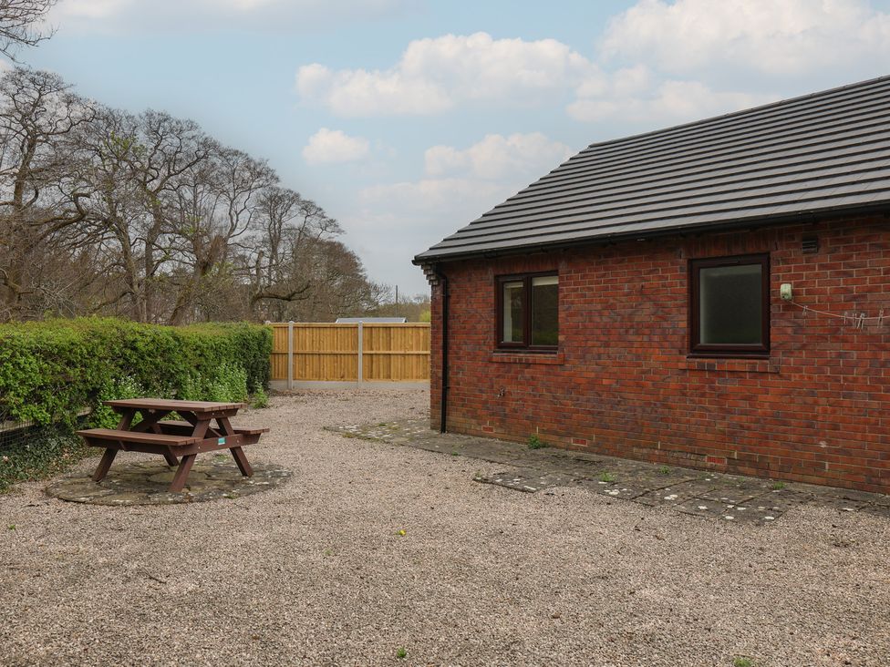 An outdoor area with a picnic table and a brick building at Bungalow 15 Eamont Park Penrith
