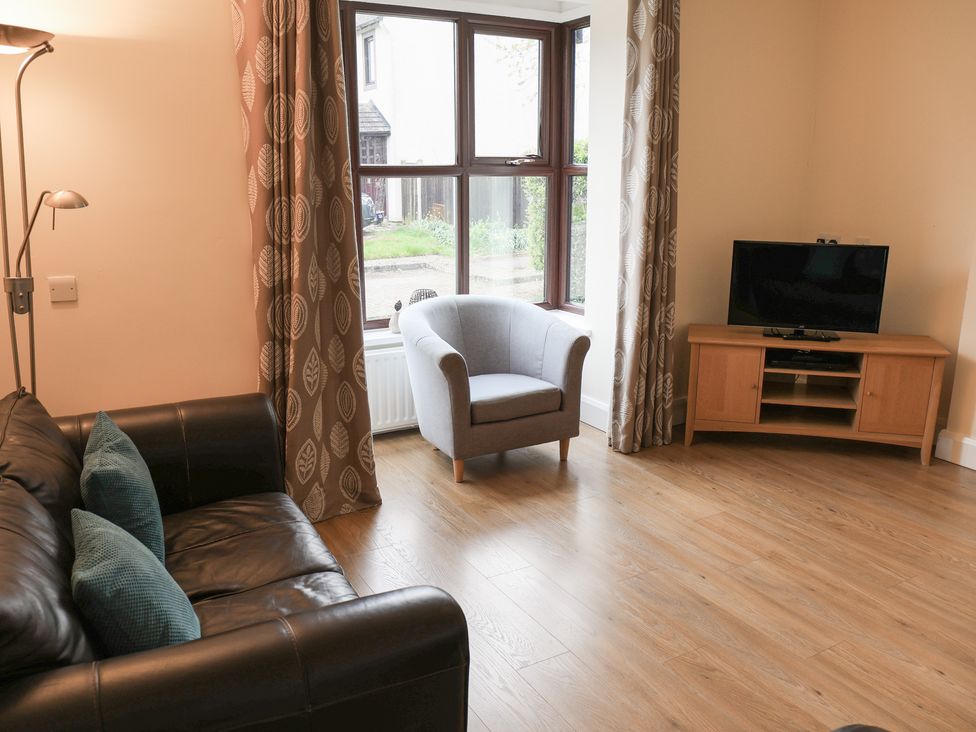 A living room with a sofa and armchair at Bungalow 14 Eamont Park Penrith