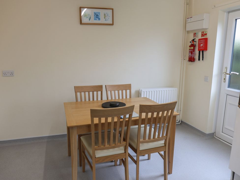 A dining room with a table and chairs at Bungalow 14 Eamont Park in Penrith