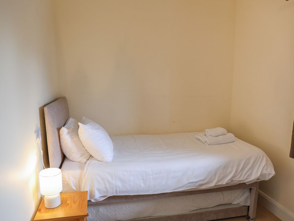 A bedroom with a bed and lamp at Bungalow 14 Eamont Park Penrith