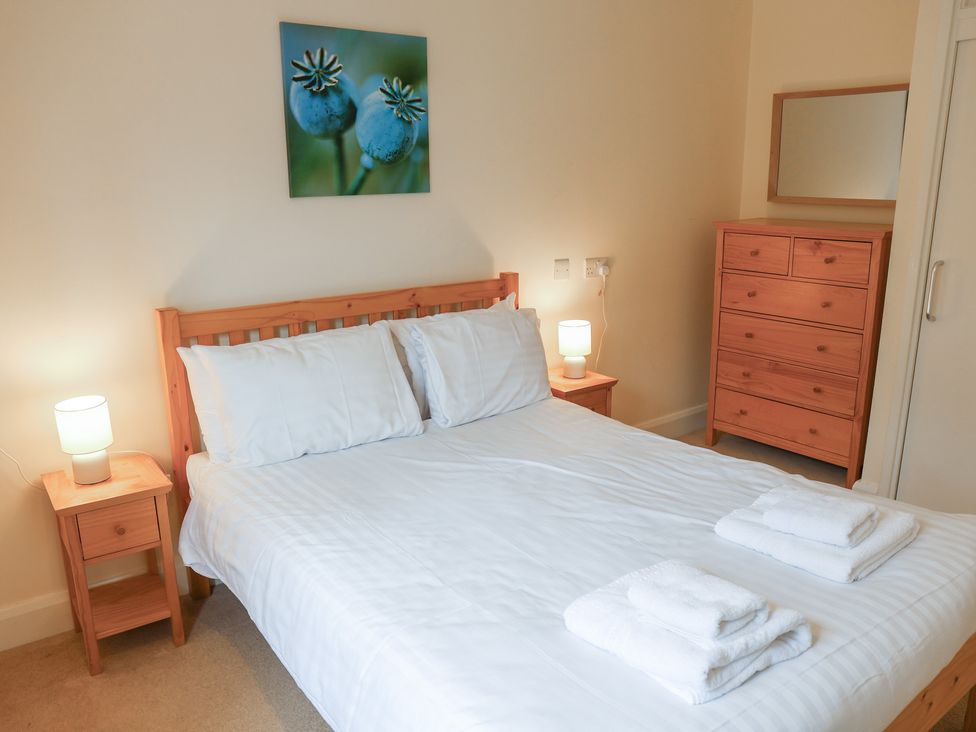 A bedroom with a bed and bedside tables at Bungalow 14 Eamont Park Penrith