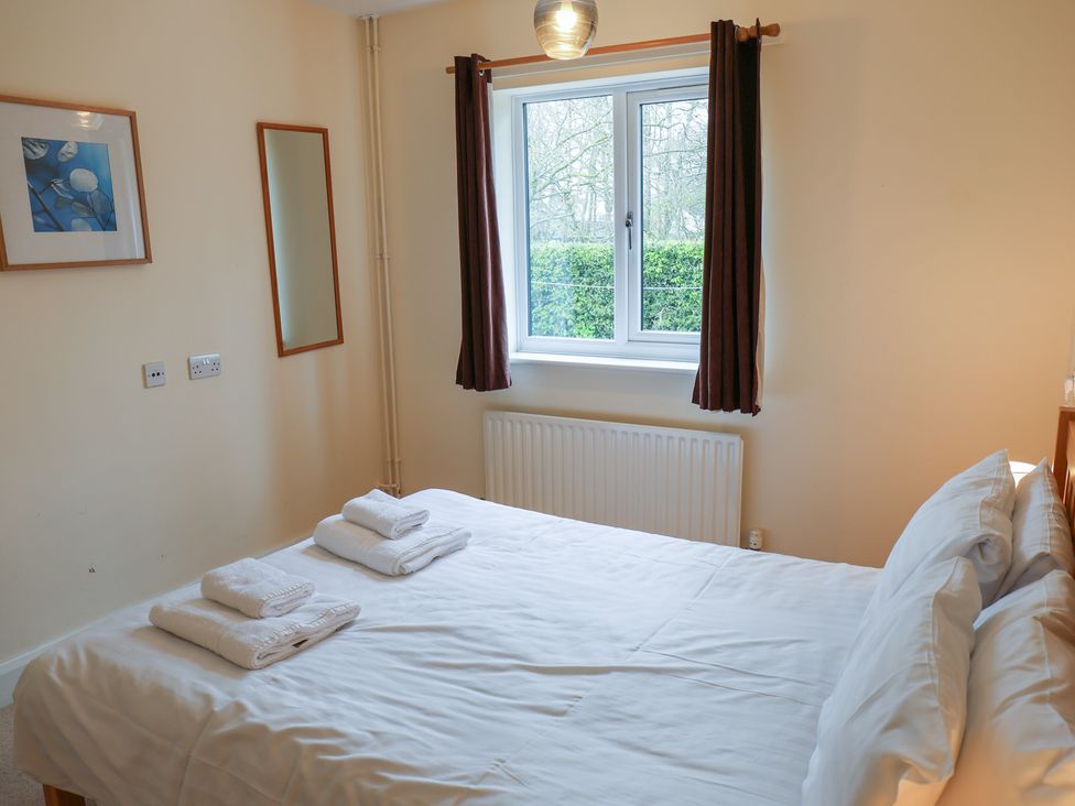 A bedroom with a double bed and window at Bungalow 14 Eamont Park, Penrith