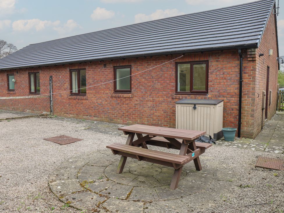 An outdoor area with a picnic table and storage box at Bungalow 14 Eamont Park Penrith