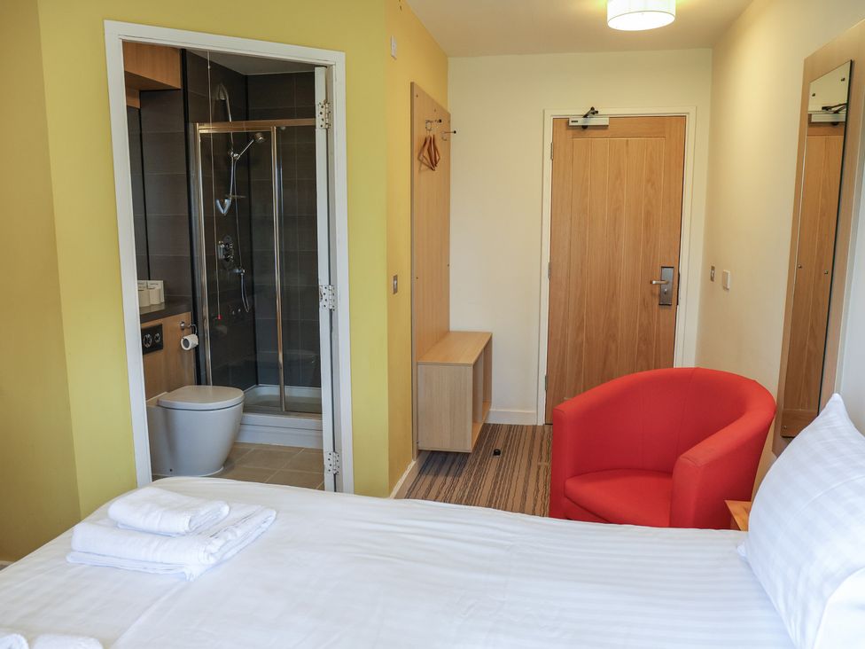 A bedroom with a bed and shower area at Bedroom 7 in Penrith