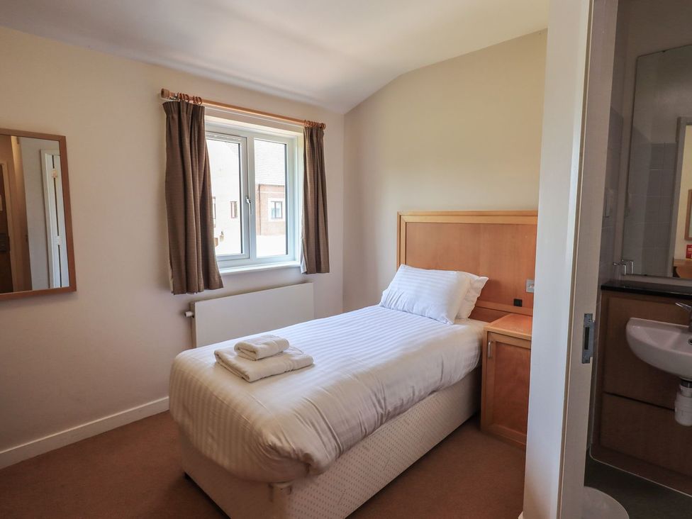 A bedroom with a single bed and a mirror at Eamont Park Ground-floor Single Bedroom Penrith