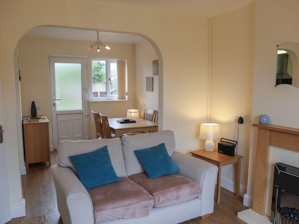 A living room with a dining area and furniture at House 8 Eamont Park in Penrith