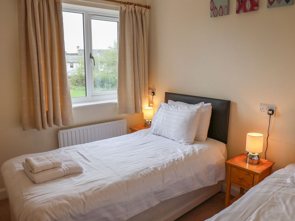 A bedroom with two beds at House 8 Eamont Park in Penrith