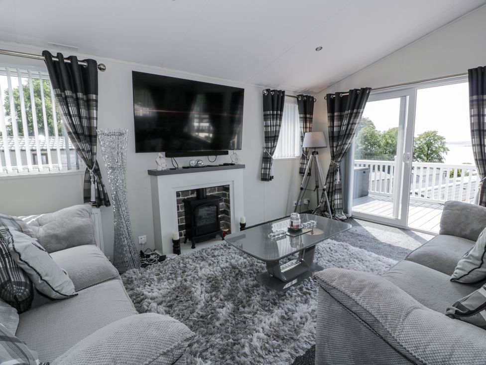 A living room with a television and fireplace at Number 42 in Wemyss Bay