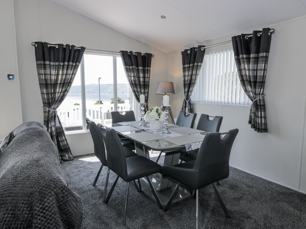 A dining room with a table and chairs at Number 42 in Wemyss Bay