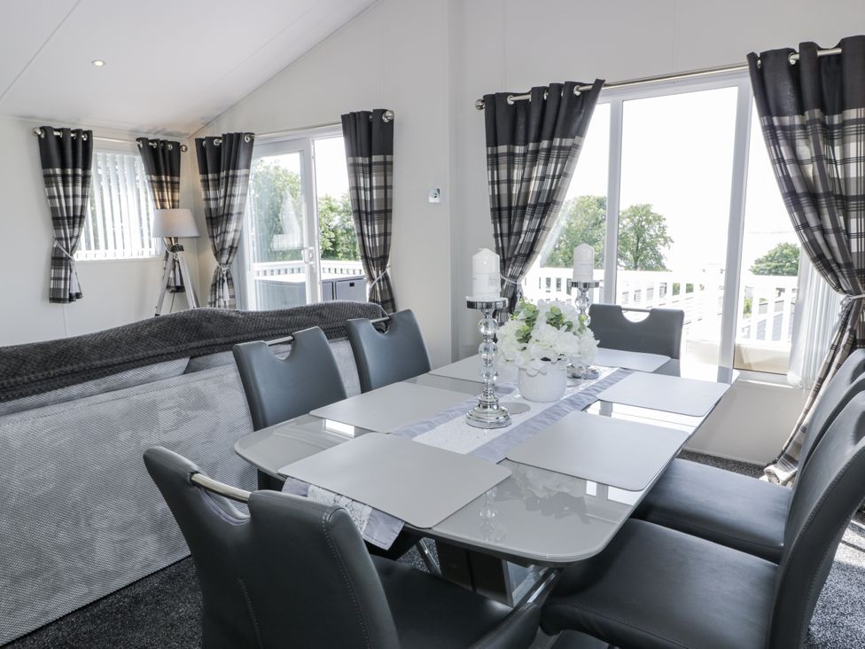 A dining area with a table and chairs at Number 42 in Wemyss Bay