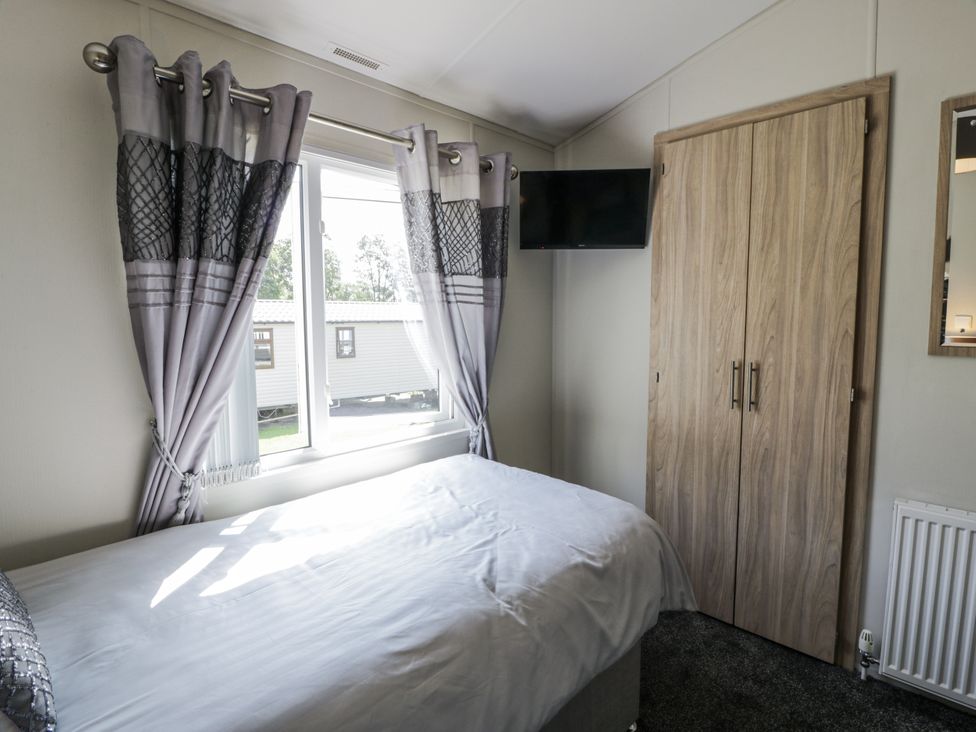 A bedroom with a bed and a window at Number 42 in Wemyss Bay