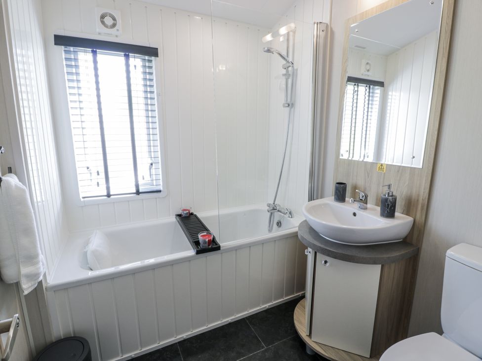 A bathroom with a bathtub and sink at Number 42 in Wemyss Bay
