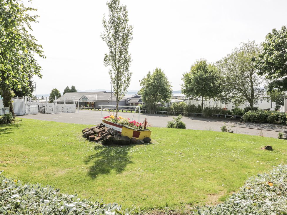 A garden with a boat planter and greenery at Number 42 Wemyss Bay