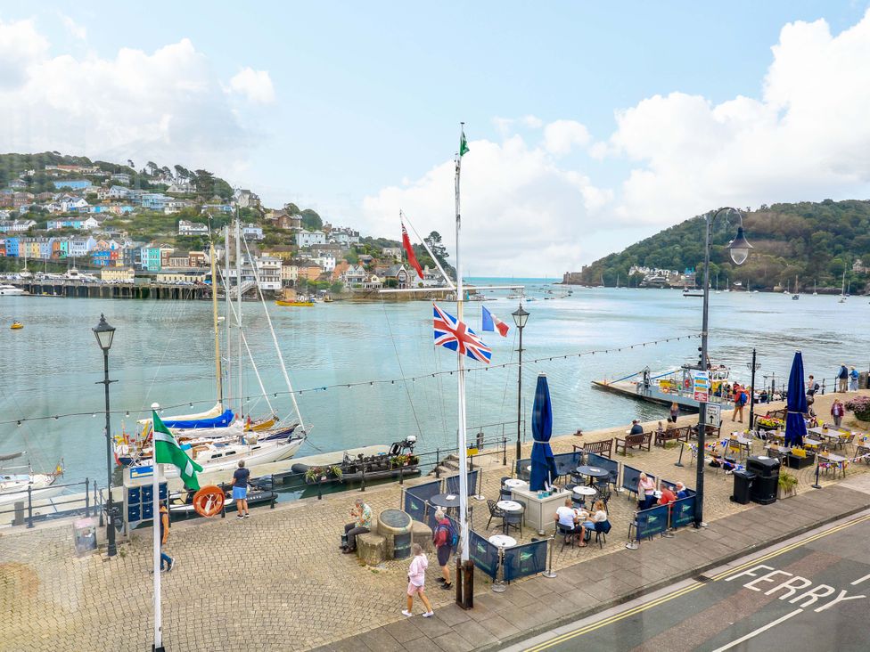 A waterfront view with boats and flags at Castleview Apartment, 21 South Embankment Dartmouth