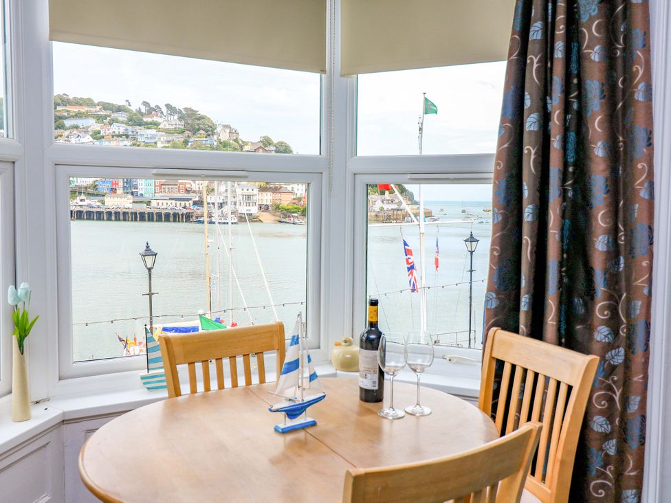 A dining room with a table and chairs at Castleview Apartment, 21 South Embankment Dartmouth