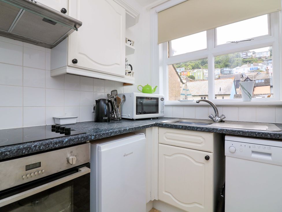 A kitchen with a sink, microwave, and kettle at Castleview Apartment, 21 South Embankment