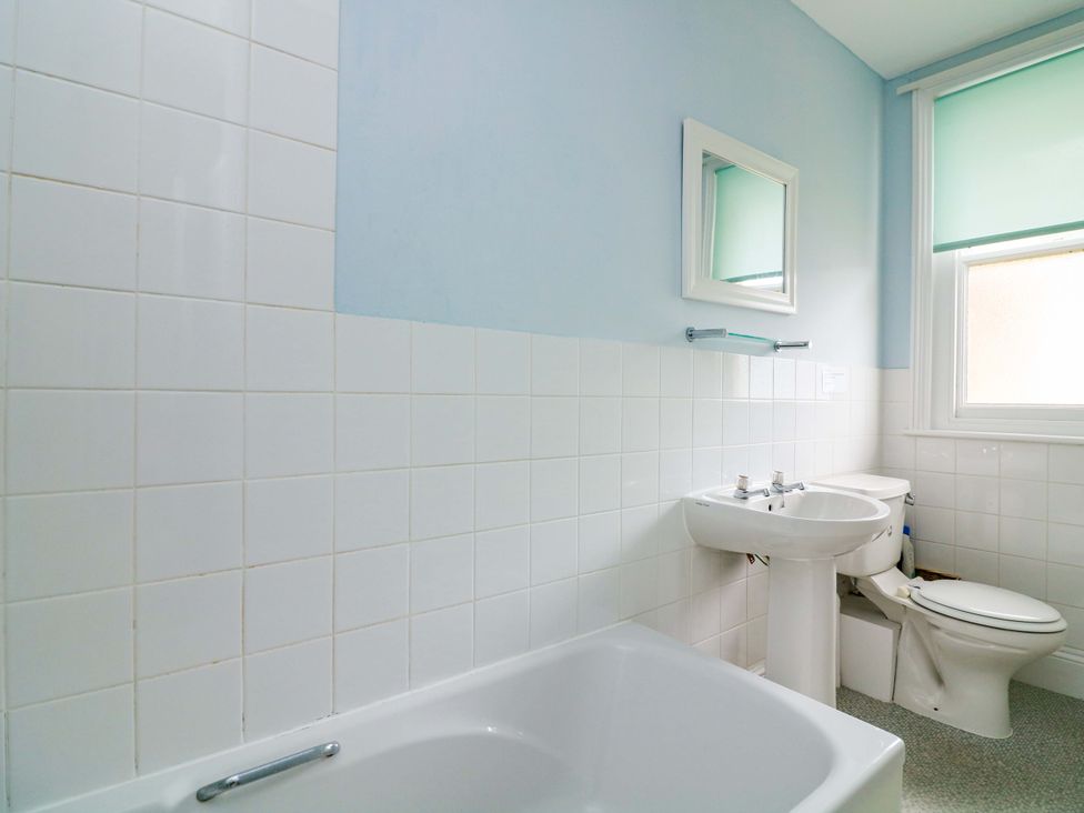 A bathroom with a sink and toilet at Castleview Apartment, 21 South Embankment in Dartmouth
