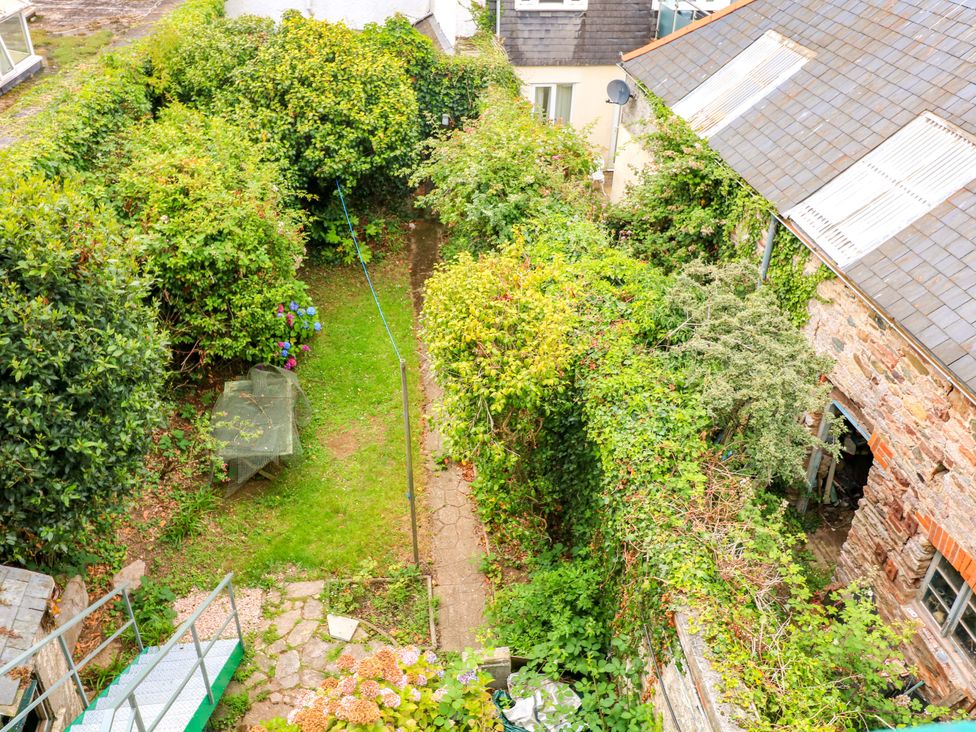 A garden with a pathway and table at Castleview Apartment, 21 South Embankment, Dartmouth