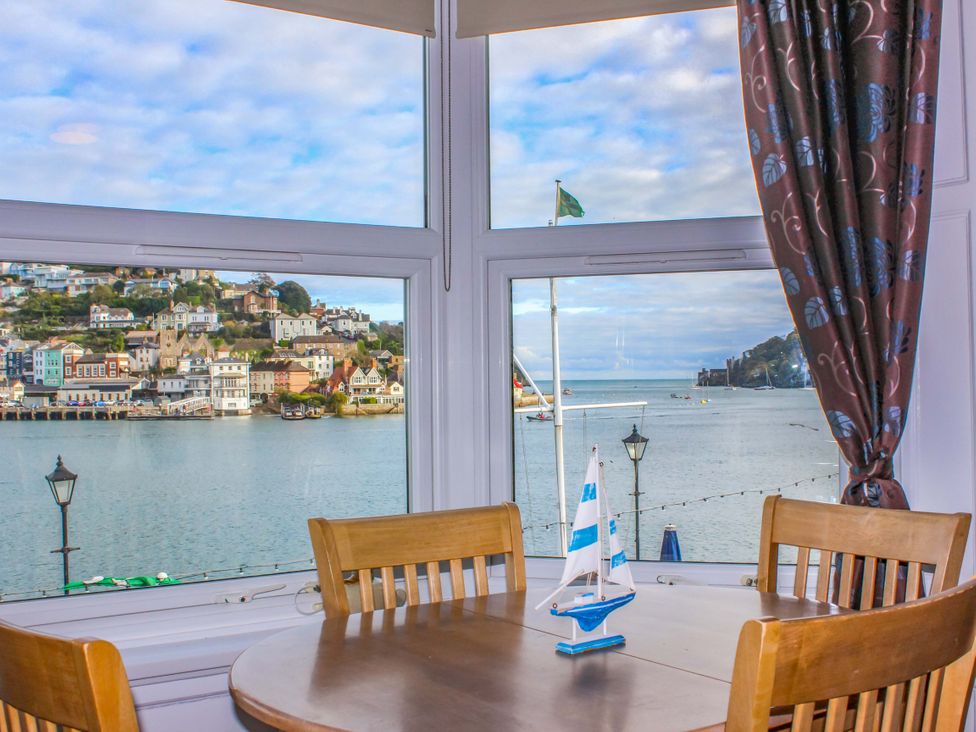 A dining room with a view of the waterfront at Castleview Apartment, 21 South Embankment, Dartmouth