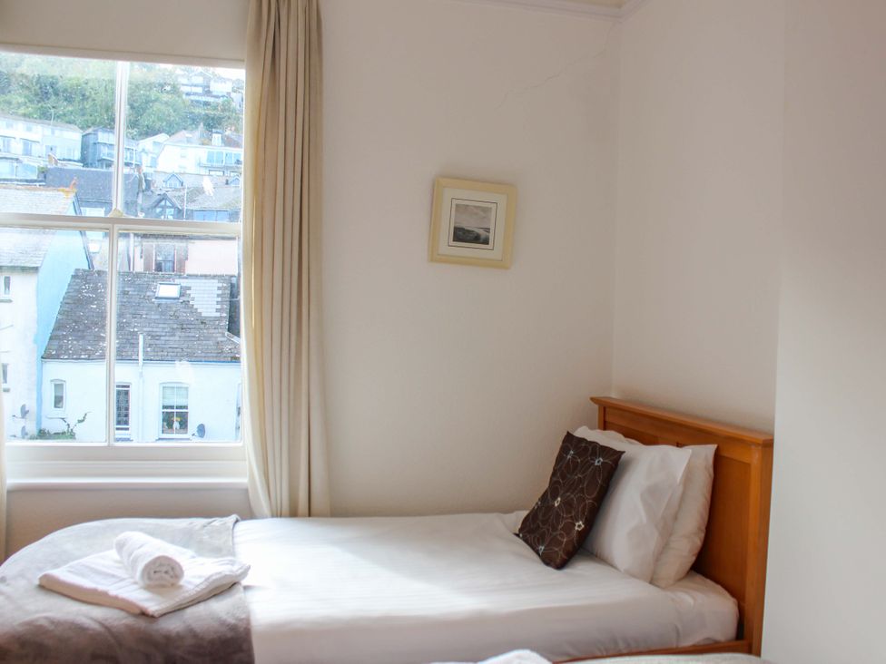 A bedroom with a bed and window at Castleview Apartment, 21 South Embankment Dartmouth