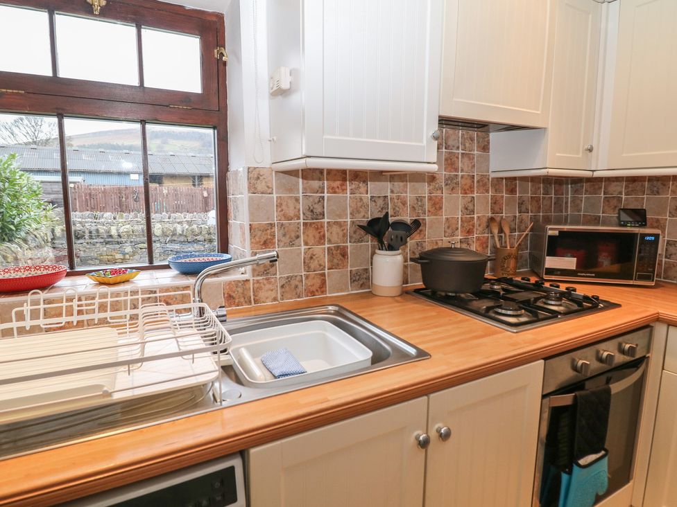 A kitchen with a sink and stove at Win Hill View Cottage in Hope Valley