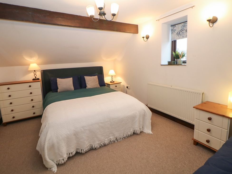 A bedroom with a double bed and furniture at Win Hill View Cottage in Hope Valley