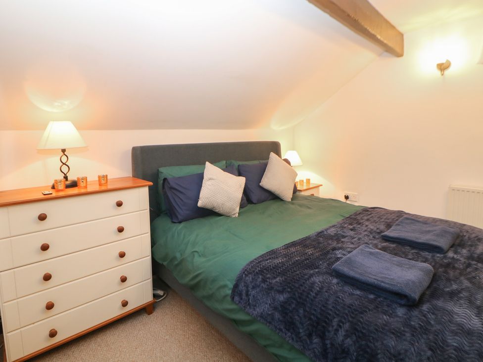 A bedroom with a bed and dresser at Win Hill View Cottage, Hope