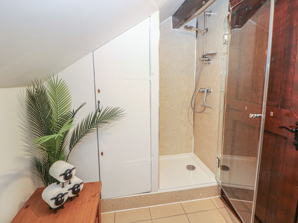 A bathroom with a shower and cabinet at Win Hill View Cottage in Hope