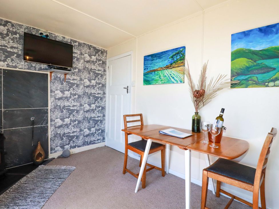 A dining room with a table and chairs at The Studio in Feock near Truro