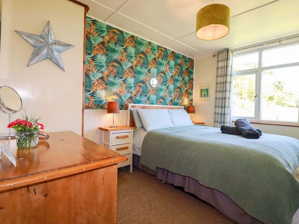 A bedroom with a bed and bedside table at The Studio in Feock near Truro