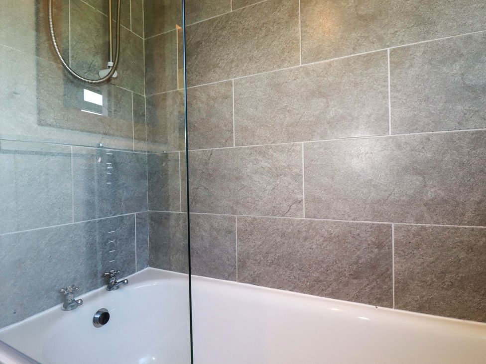 A bathroom with a bathtub and shower at The Studio in Feock near Truro