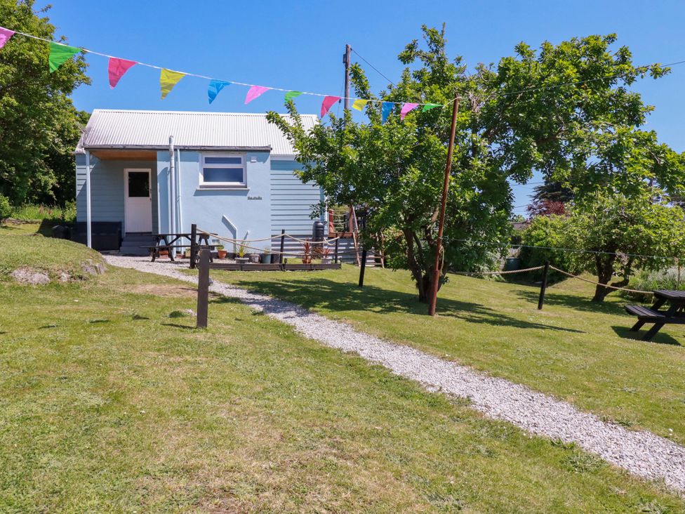A house with trees and a path in the garden at The Studio Feock near Truro