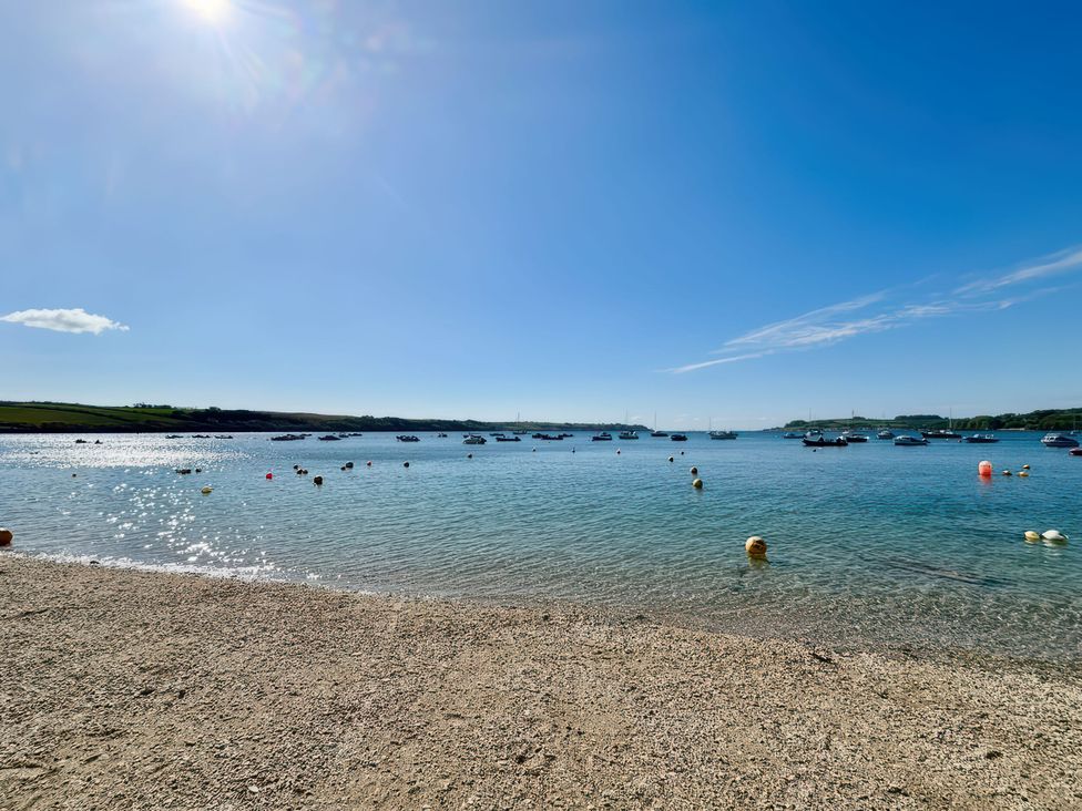 A view of boats on water with a beach at The Studio Feock near Truro