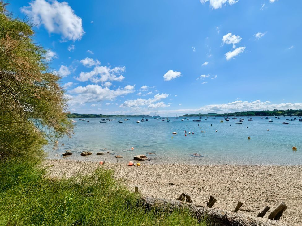 A beach view with boats on the water at The Studio Feock near Truro